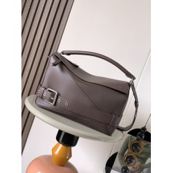 1180 Large Glossy Cowhide Puzzle Biker HandbagPuzzle with distinctive geometric lines that define the rectangular shapeThis large version is made of glossy cowhide leather with biker-inspired detailingCan be worn over the shoulderCrossbody or handheldDeta