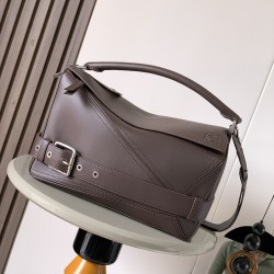 1180 Large Glossy Cowhide Puzzle Biker HandbagPuzzle with distinctive geometric lines that define the rectangular shapeThis large version is made of glossy cowhide leather with biker-inspired detailingCan be worn over the shoulderCrossbody or handheldDeta