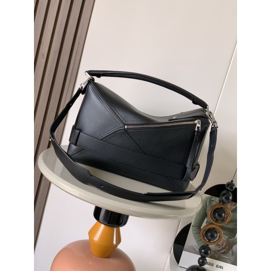 1180 Original Large Glossy Cowhide Puzzle Biker HandbagPuzzle with distinctive geometric lines outlining the rectangular shapeThis large version is made of glossy cowhide leather with biker detailsShoulder or hand carryCrossbody or hand carryRemovable and