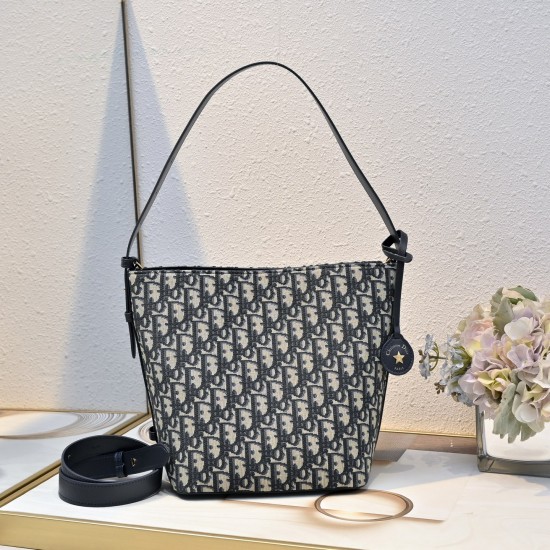 210 This Diorstar bucket bag from the Spring 2016 Ready-to-Wear collection is a smart, practical design with a versatile aesthetic crafted in materials such as blue Oblique printed fabric and embellished with smooth cowhide details in the same hue for a s