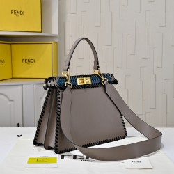 410 Model 33200 New! New in stock New in stock Iconic Peekaboo ISeeU large handbag Handmade leather weave with signature twist lock on both sidesSoft leather lining in the same color visible from the outsideTwo compartments separated by a rigid dividerFea