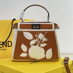 Upgraded Cowhide 390 with BoxFendi's new iconic Peekaboo pouch in black canvas and patent leather is engraved with a rose motif displaying a natural canvas backgroundThe sides are decorated with a signature twist lockTwo compartments are lined with canvas