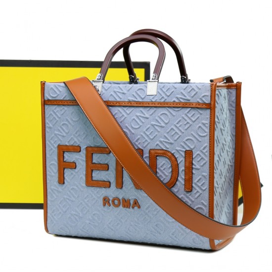 Lot 330FEND1 Sunshine medium tote bag in denim with FENDI Mirror pattern all over brown rigid leather handles decorated with FENDI ROMA features spacious lined interior compartments leather silhouette and gold finish metal pieces with two carry handles an
