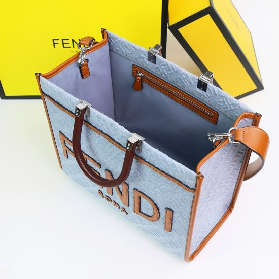 Lot 330FEND1 Sunshine medium tote bag in denim with FENDI Mirror pattern all over brown rigid leather handles decorated with FENDI ROMA features spacious lined interior compartments leather silhouette and gold finish metal pieces with two carry handles an